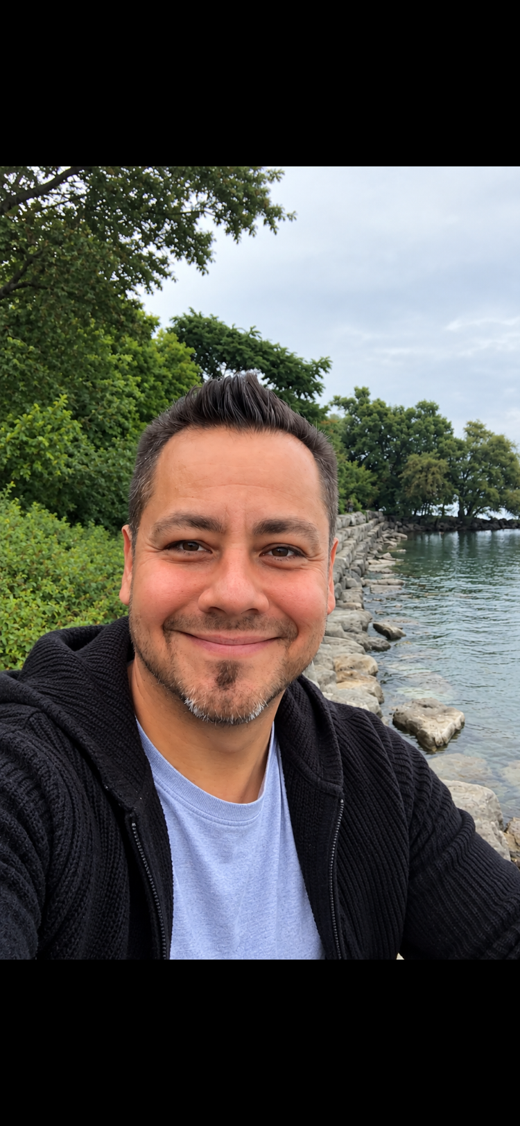 Jason Acosta outdoors by the waterfront